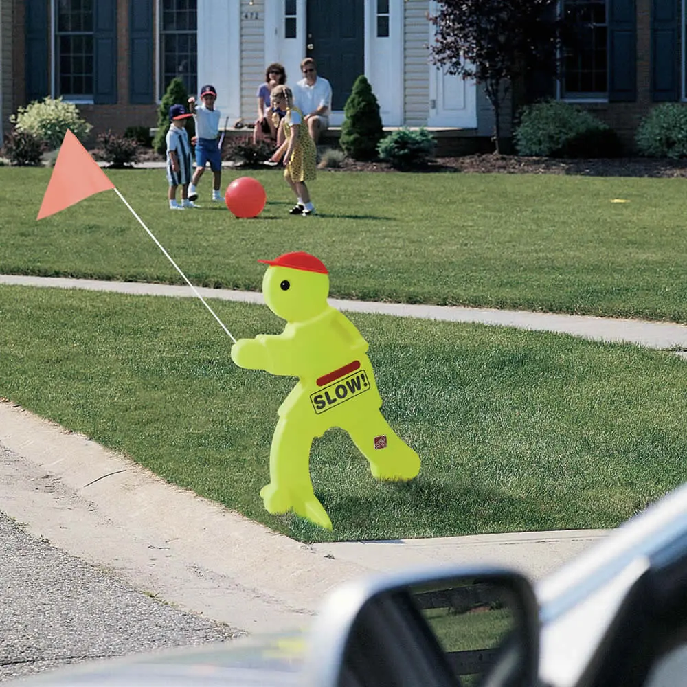 A garish sign shaped as a child, with a label, &ldquo;SLOW!