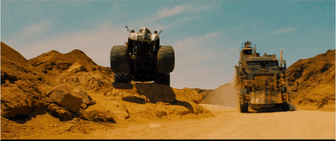 A car jumping off a sand dune